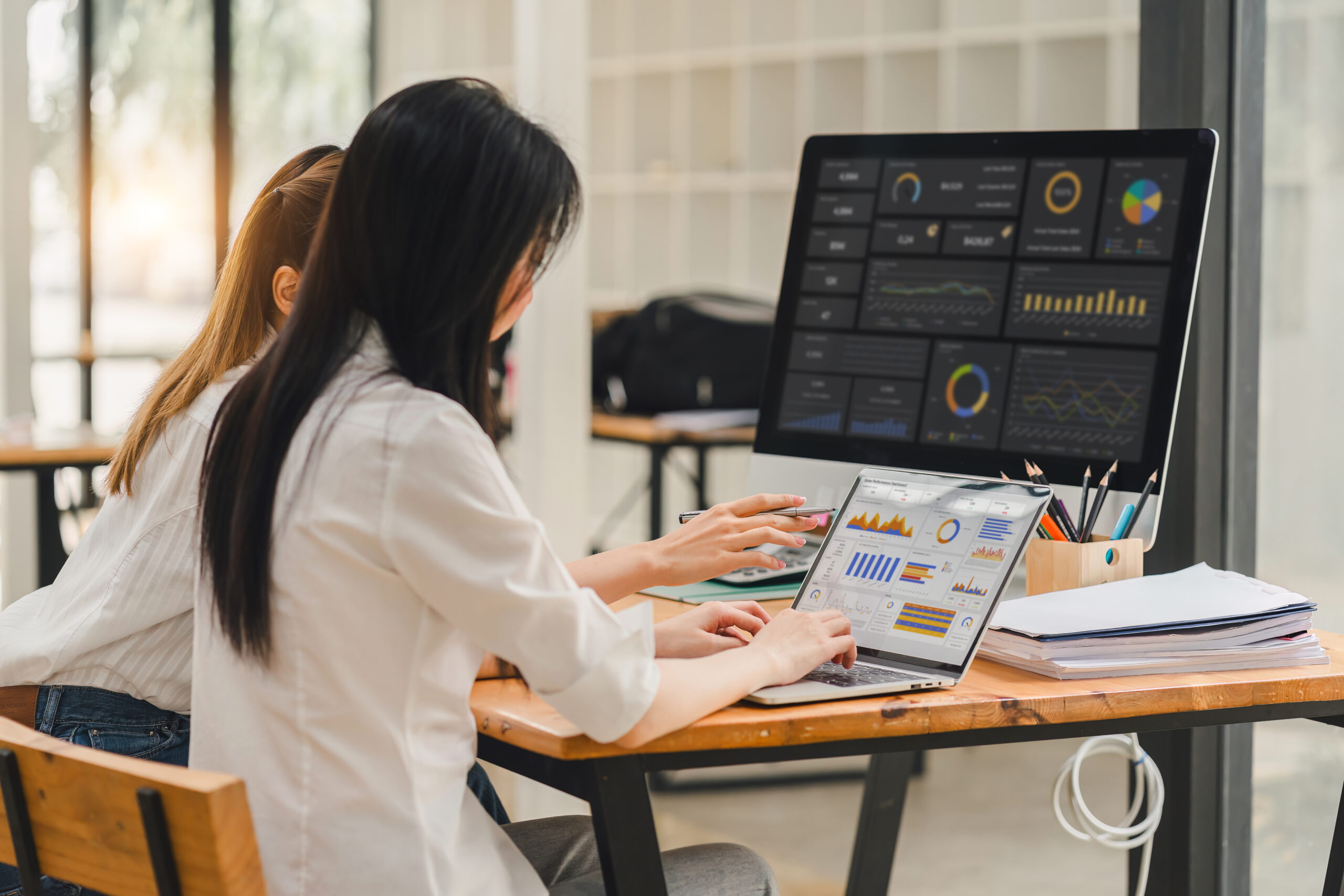 Two data analysts Working on data analysis dashboard for business strategy Two data analysts Working on data analysis dashboard for business strategy